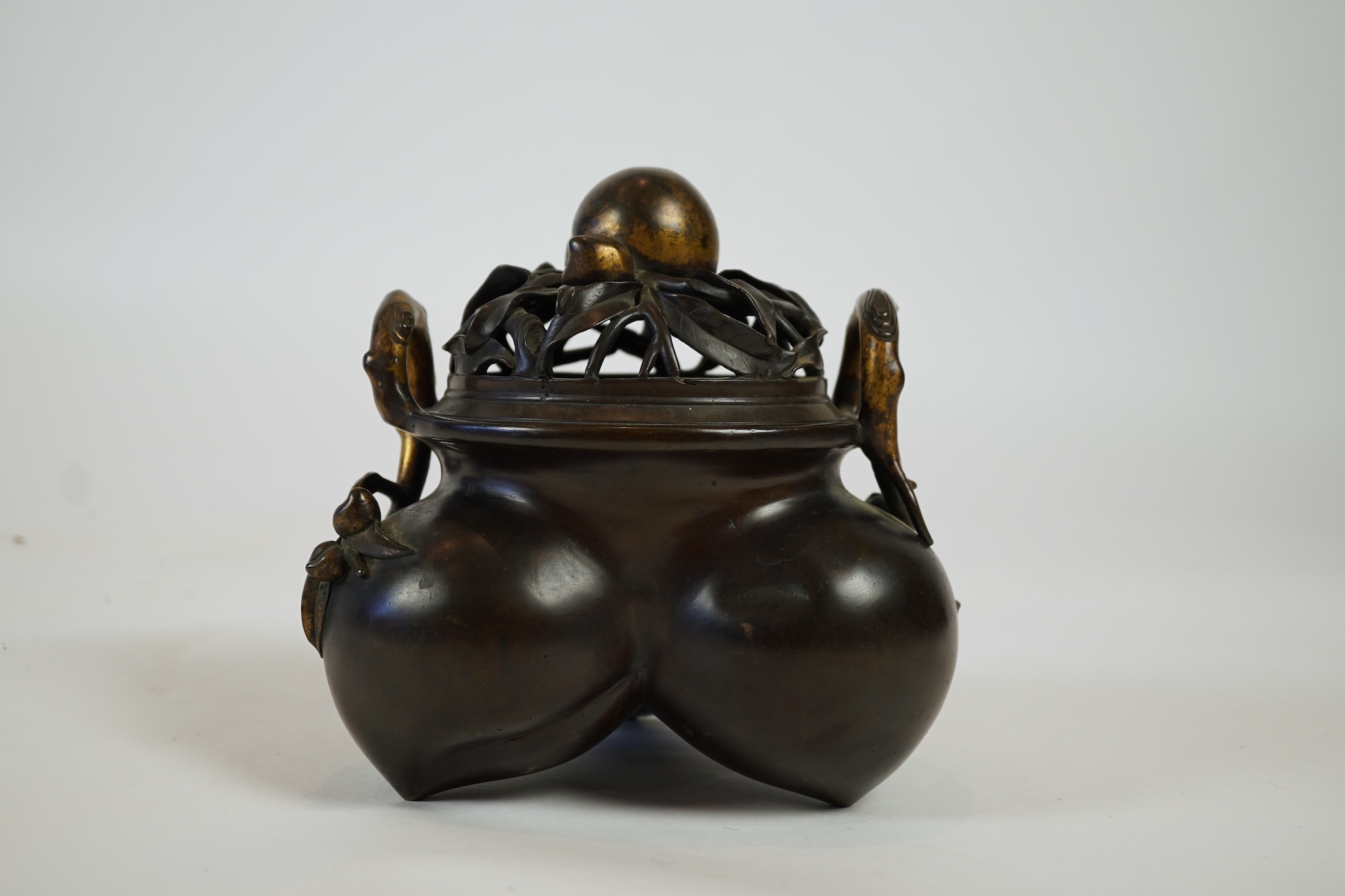 A large Chinese bronze and parcel gilt ‘peach’ censer and cover, Li, 17th/18th century